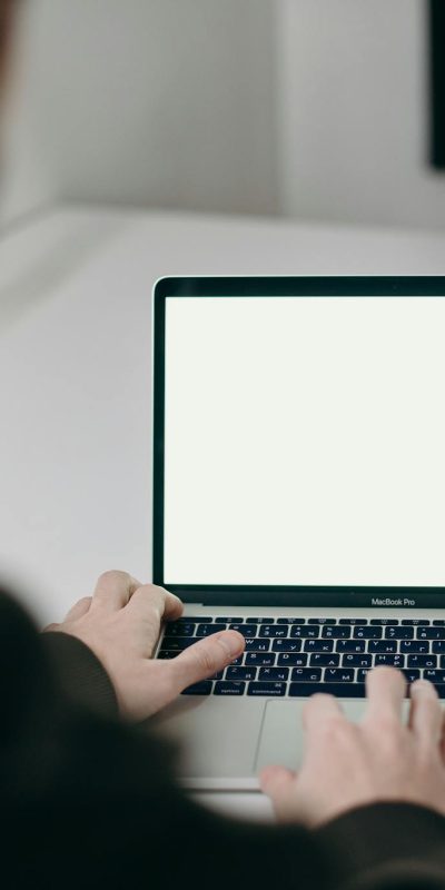 Person Using Macbook Pro on White Table